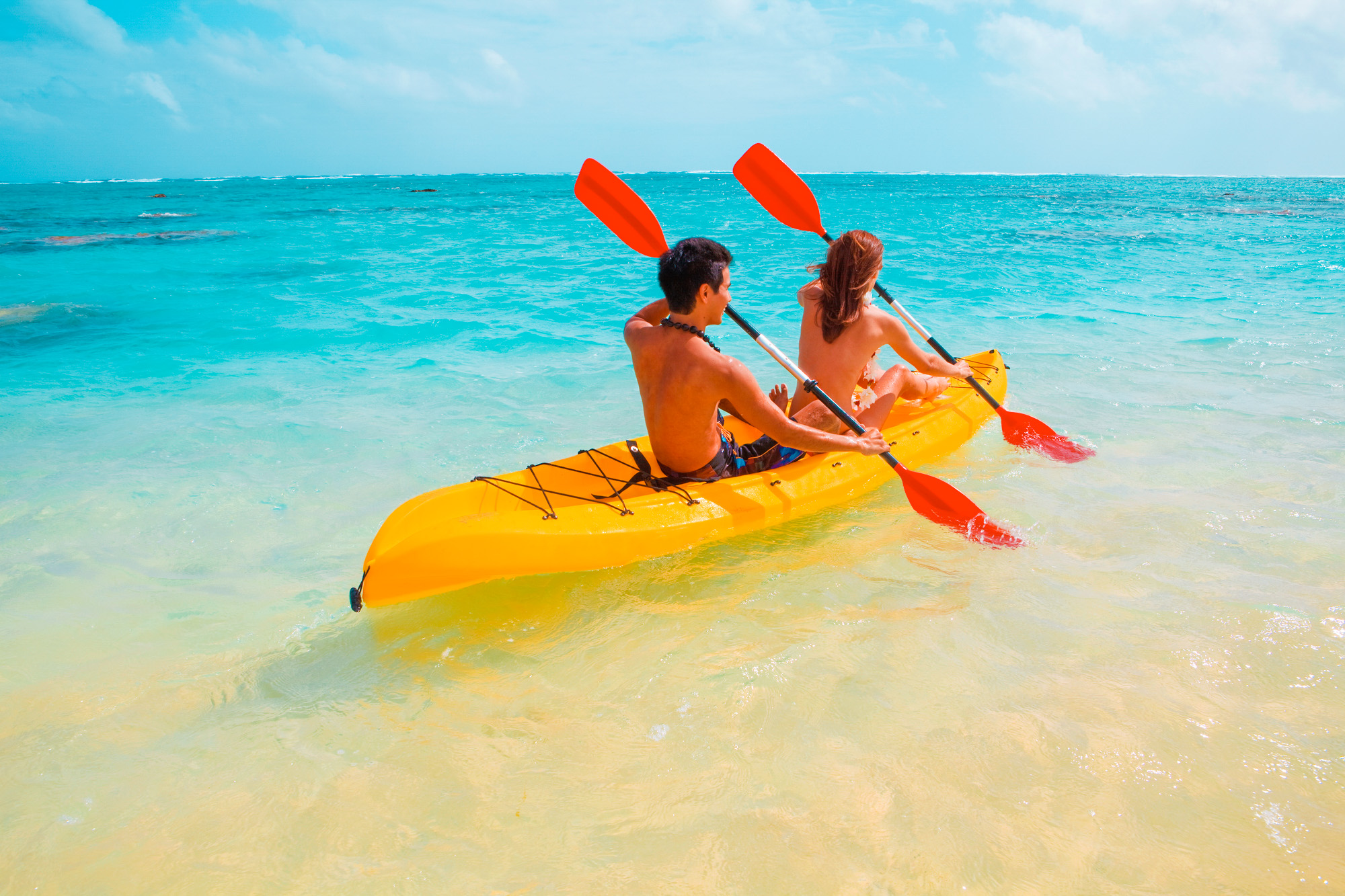 active couple kayaking in hawaii