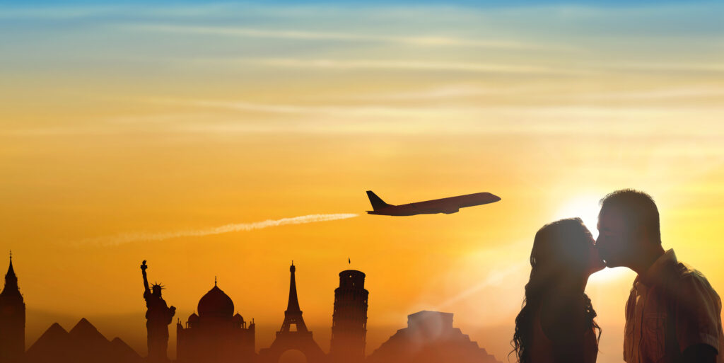 shadow of a couple kissing with a airplane flying and different country landmarks at the background.