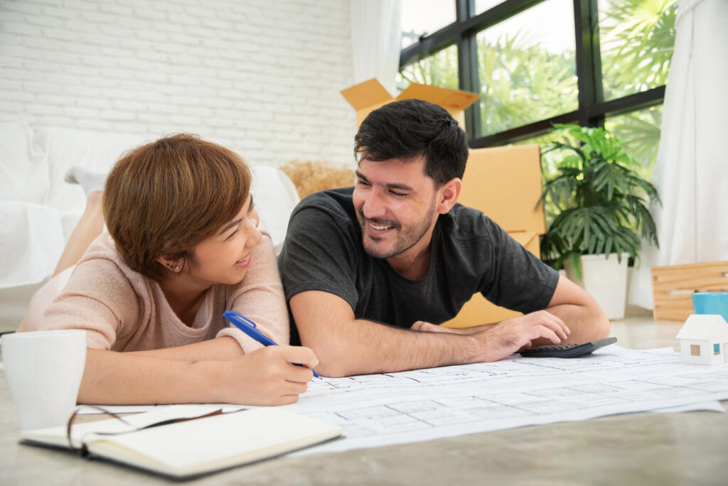 a couple enjoying planning their wedding and using the floor as table.