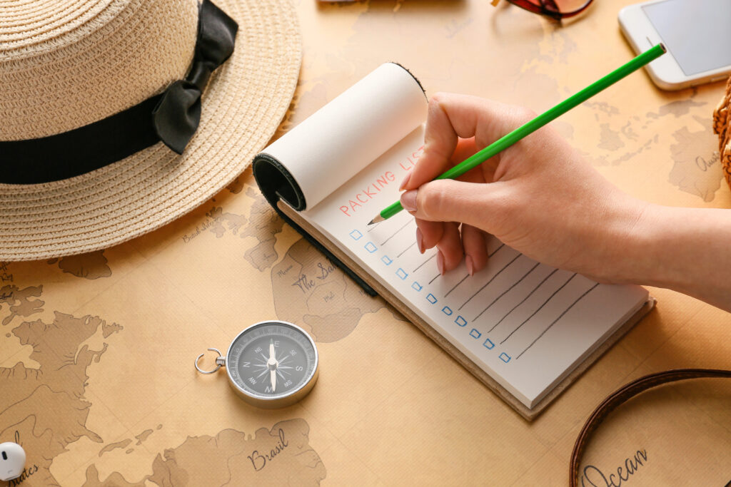 Woman making check-list of things to pack for travel